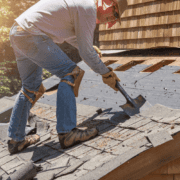 A professional roofing contractor working on a roof replacement project.