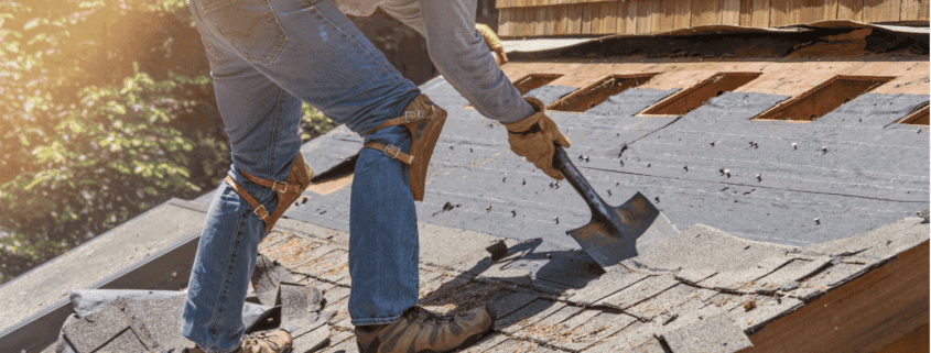 A professional roofing contractor working on a roof replacement project.