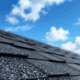 A close-up view of asphalt shingles showing the texture and granules.