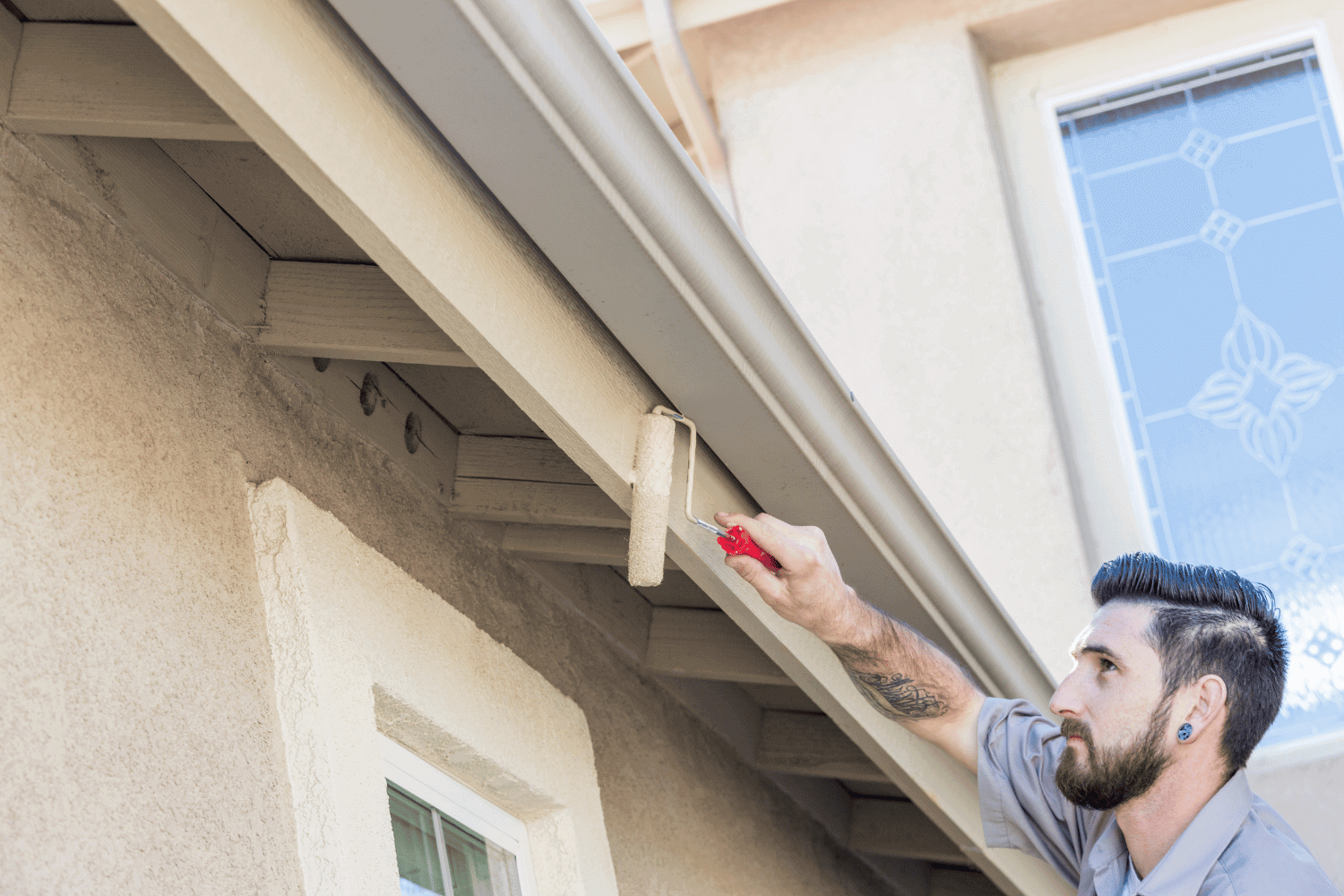 A professional installing fascia boards on a house.