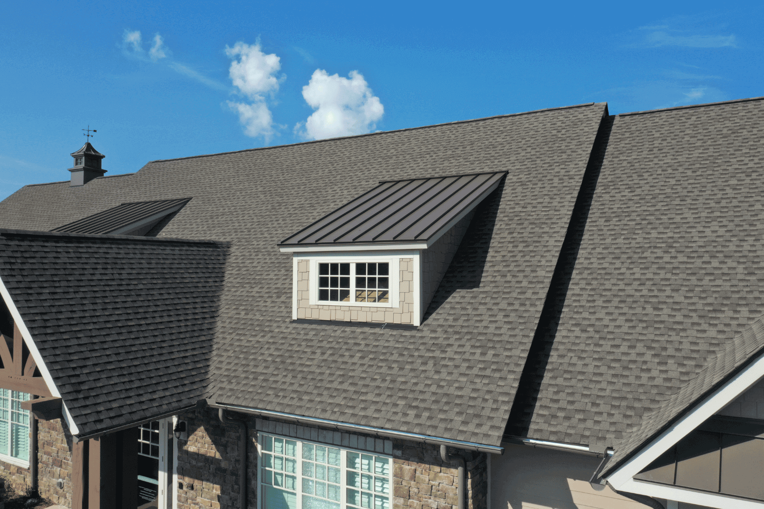 A house with impact resistant roof shingles, showcasing their protective features