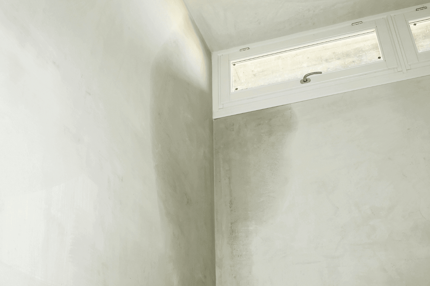 A professional inspecting a basement for persistent water seepage issues
