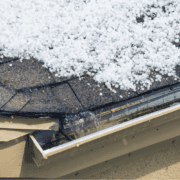 A professional roofing contractor inspecting a hail-damaged roof