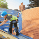 A professional roofing contractor installing impact resistant shingles on a house