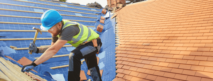 A professional roofing contractor installing impact resistant shingles on a house