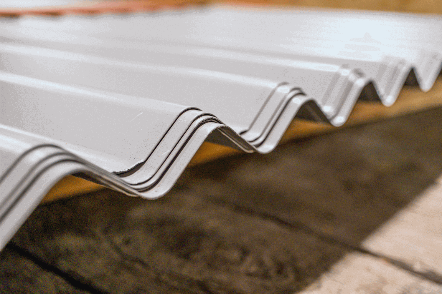 An image comparing standing seam metal roofs and corrugated metal roofs