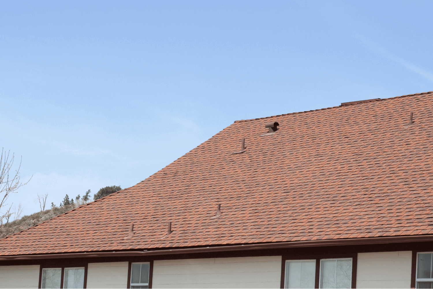 Different roofing systems suitable for various slopes, featuring asphalt shingles and metal roofing