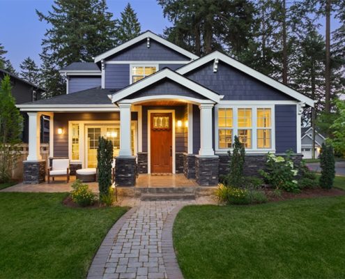 A charming home with a welcoming walkway leading up to the front door, surrounded by greenery and a pleasant atmosphere