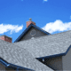 A house with a newly installed roof showcasing asphalt shingles.