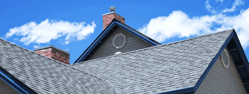 A house with a newly installed roof showcasing asphalt shingles.