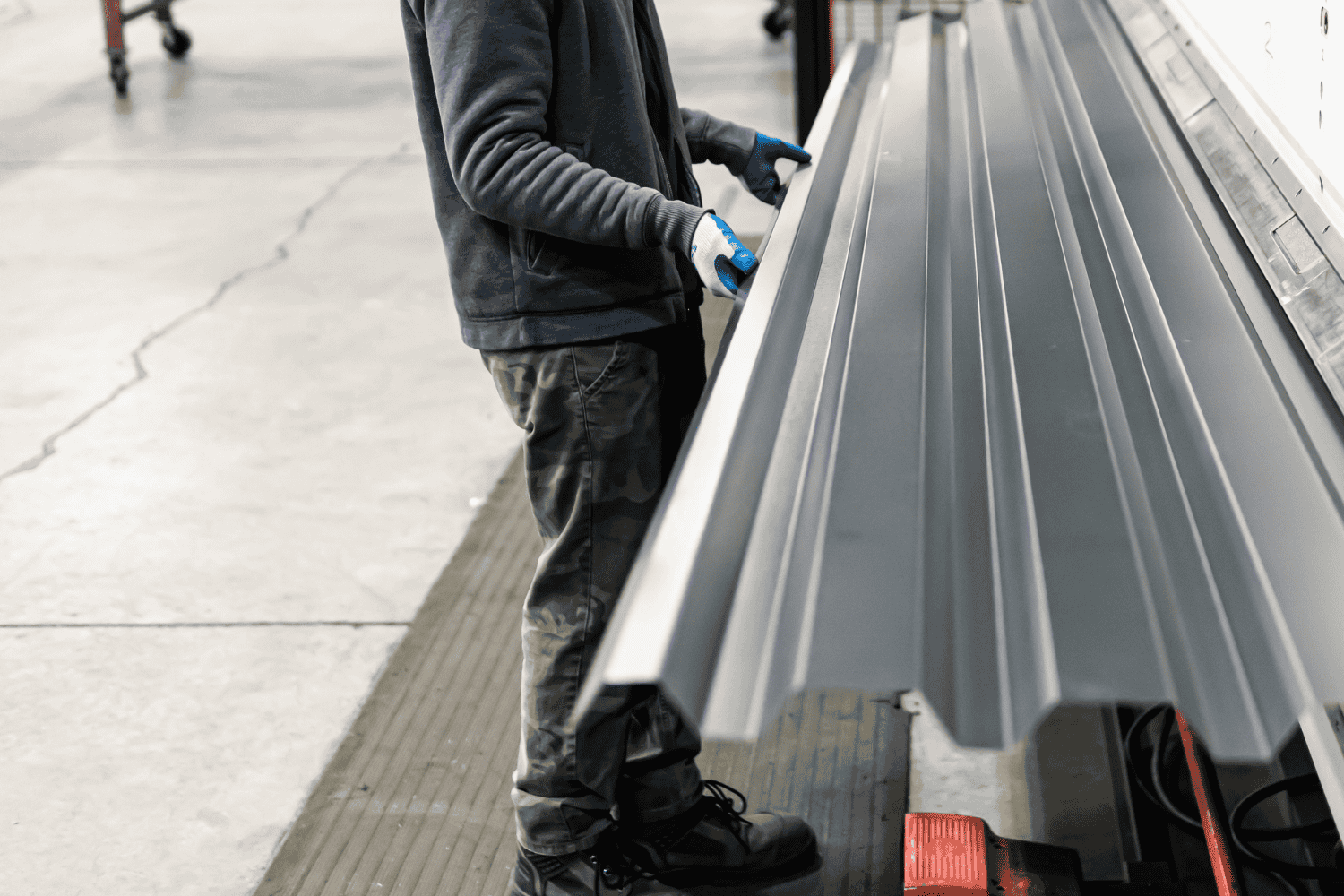 The installation process of corrugated metal roofing panels.