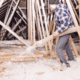 A person carefully walking in an attic filled with blown insulation..