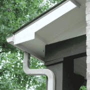 Properly secured downspouts in a gutter system.