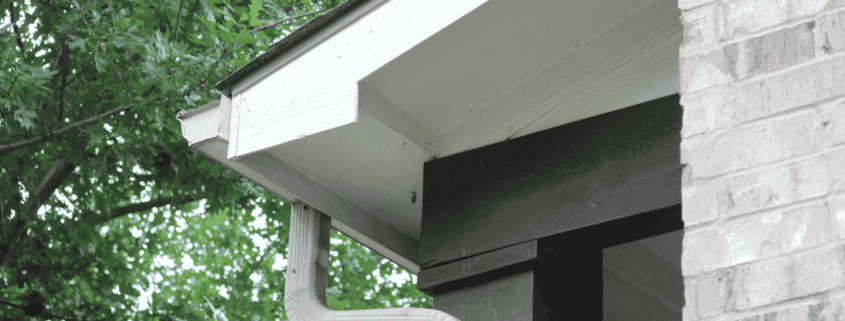 Properly secured downspouts in a gutter system.