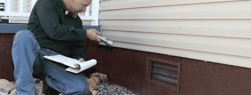 Inspecting the exterior of a home for foundation issues.