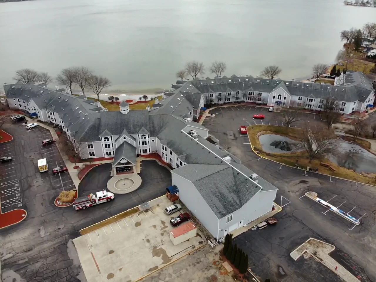 Add 10+ Years to Your Flat Roof Without A Full Tear-Off With Commercial Roofing In South Bend, IN 2 An aerial shot showcases a sprawling waterfront commercial roofing project across a multi-building residential complex.