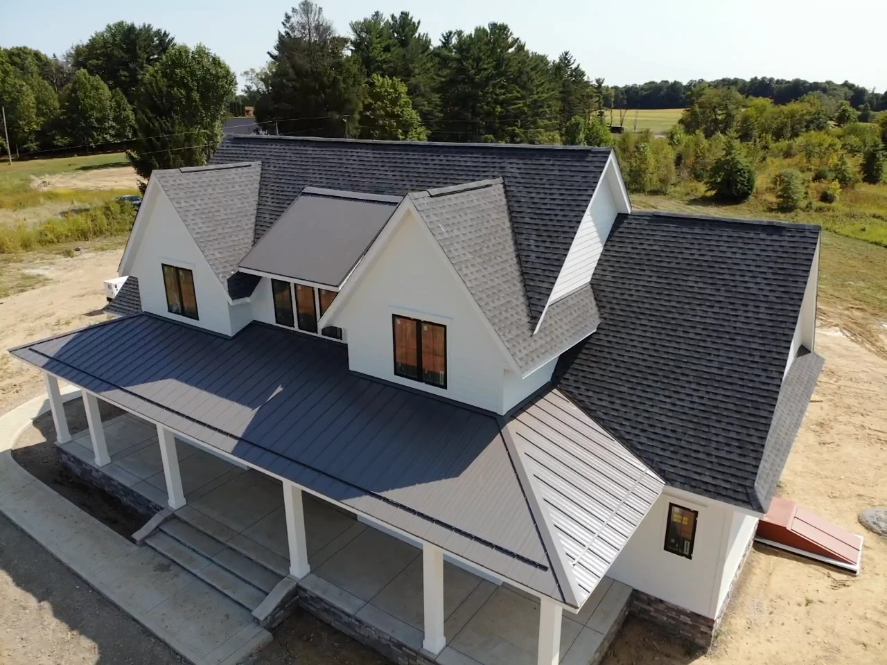 Why Some Warsaw, IN Windows Just Need A Repair, Not A Replacement 2 An aerial view highlights a modern farmhouse with white gables, dark roof accents, and newly installed replacement windows.